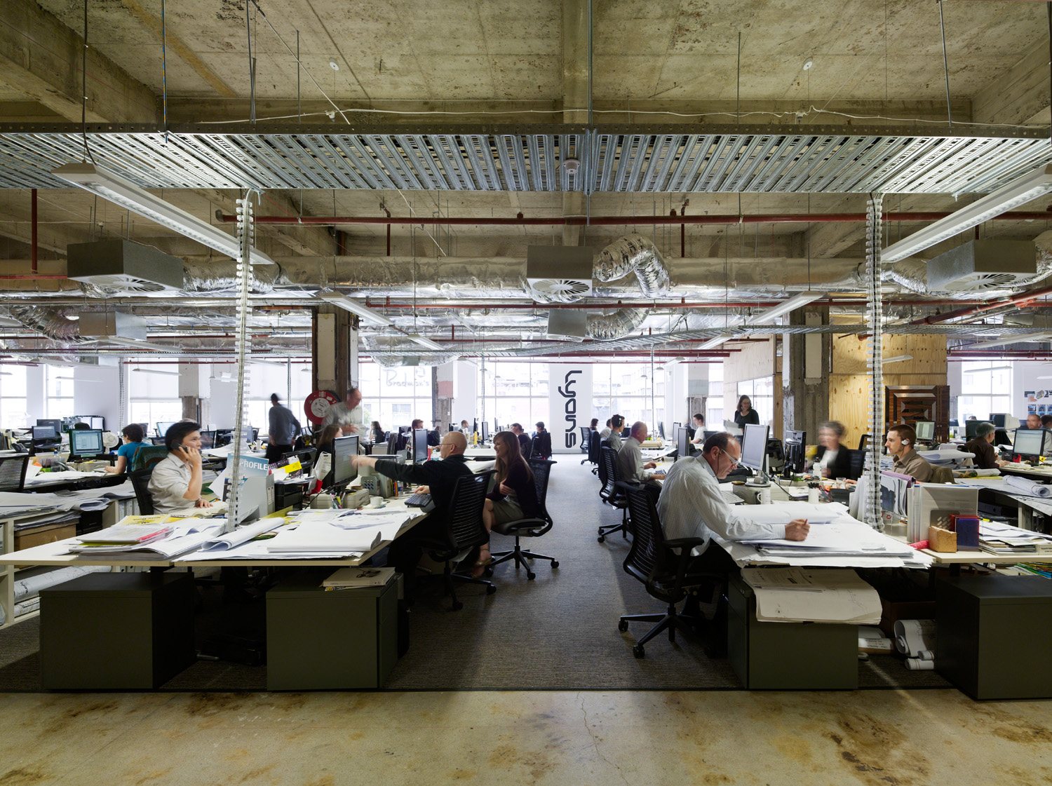 Open office with professionals working at computers